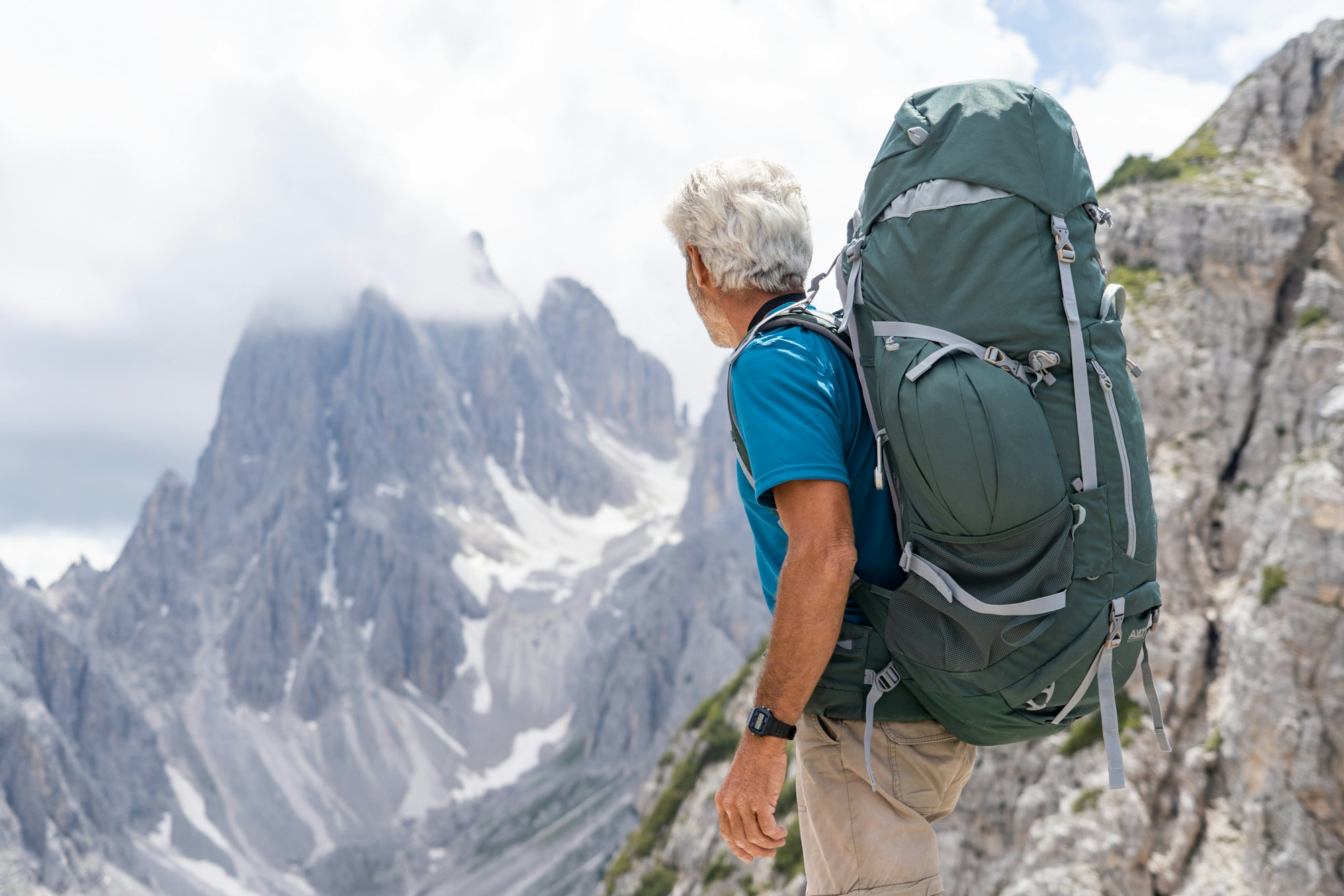 An older man hiking in the mountains
