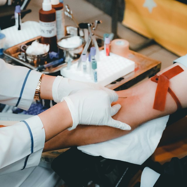 A blood sample being taken from an arm